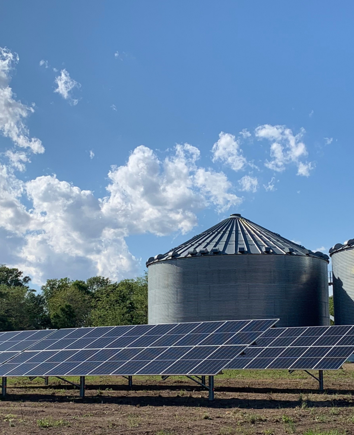 Solar panels installed at the base of an Arkansas grain bin operation